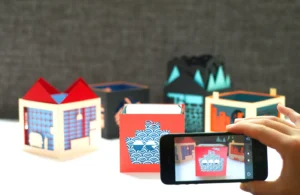 Handcrafted three-layer paper pop-up book by Julie Stephen Chheng featuring Uramado AR animations and Japanese-inspired window designs.