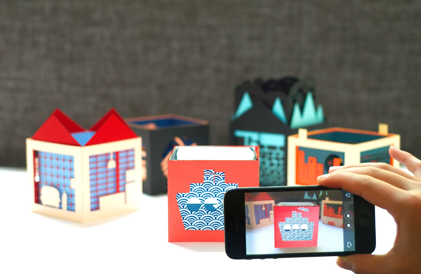 Handcrafted three-layer paper pop-up book by Julie Stephen Chheng featuring Uramado AR animations and Japanese-inspired window designs.