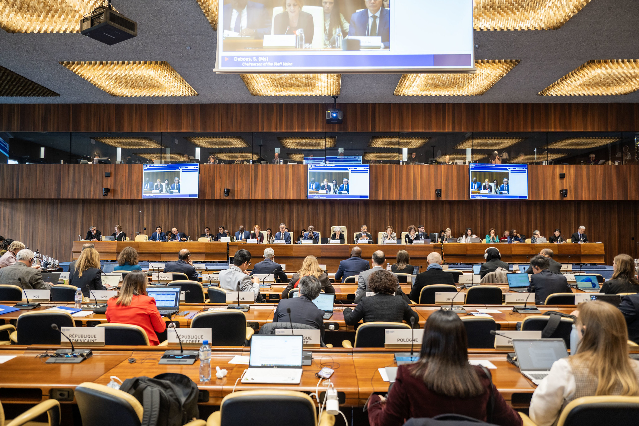 A wide-angle view of the International Labour Organization (ILO) Governing Body in session at the headquarters in Geneva, showing delegates seated in the assembly hall.