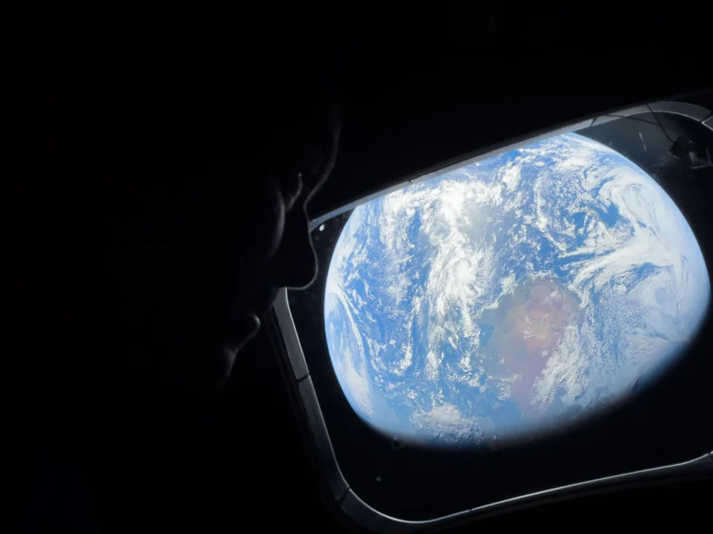 NASA Astronaut Reid Wiseman looking out the Orion spacecraft window during the Artemis II lunar flyby.